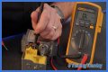 How do you test a Honeywell gas valve with a multimeter?
